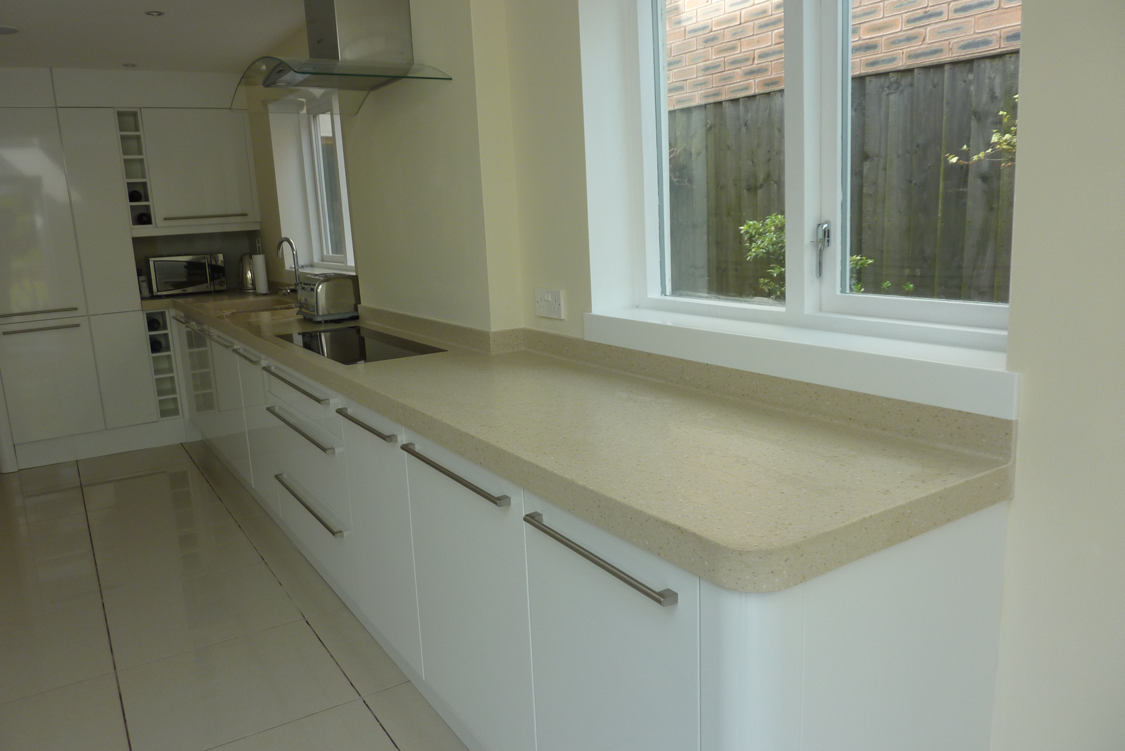 Corian worktops with coved up stands and inset corian sink and corian window sills