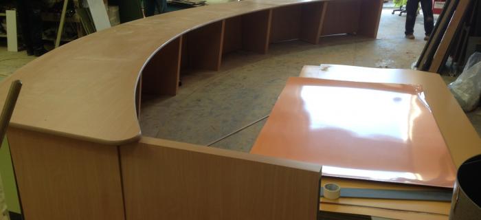 University reception counter - Liverpool . Top manufactured from 25 mm Mdf and  laminated with formica laminate with clear lacquered edges front of counter made from flexi ply and   mdf and laminated in green fomica .